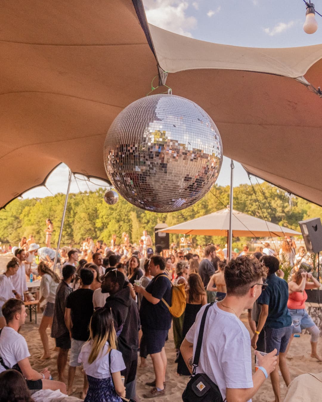 A mirrored light sphere above the SUNDAZE field by the Berlin lake