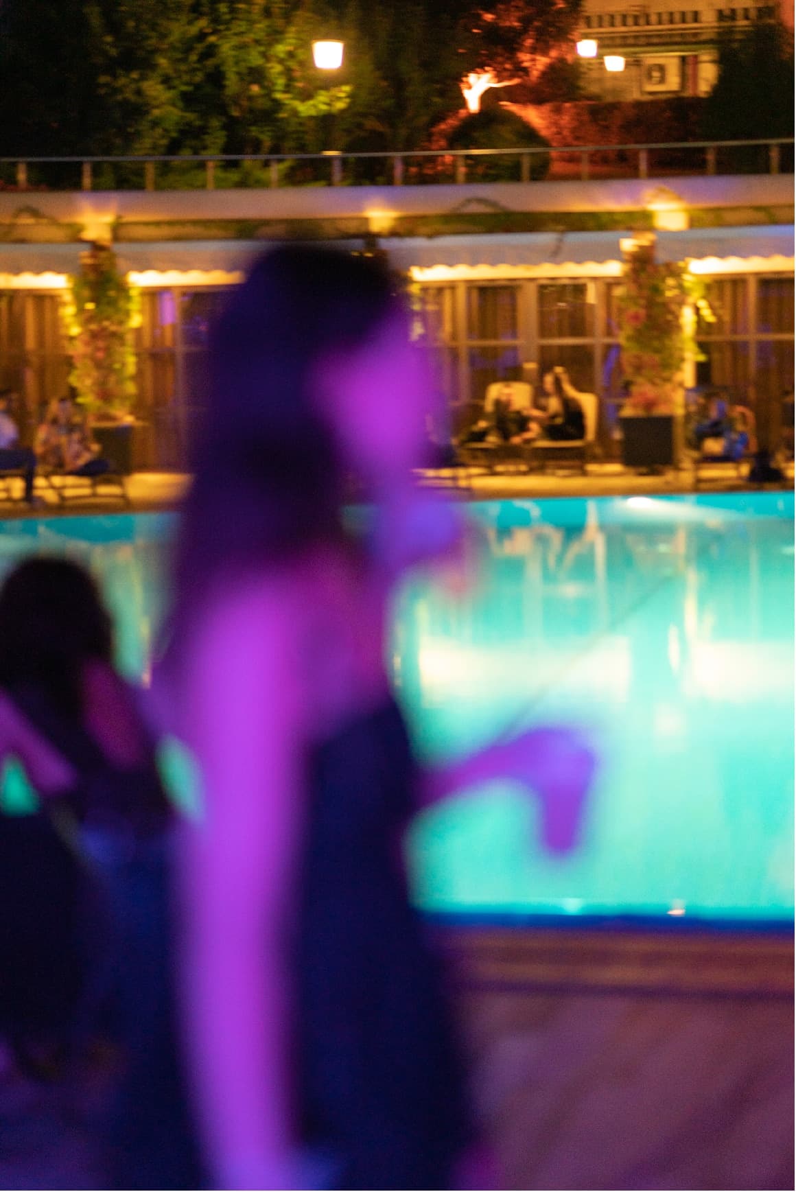 A dancer moving through blue and violet light at KULÜP