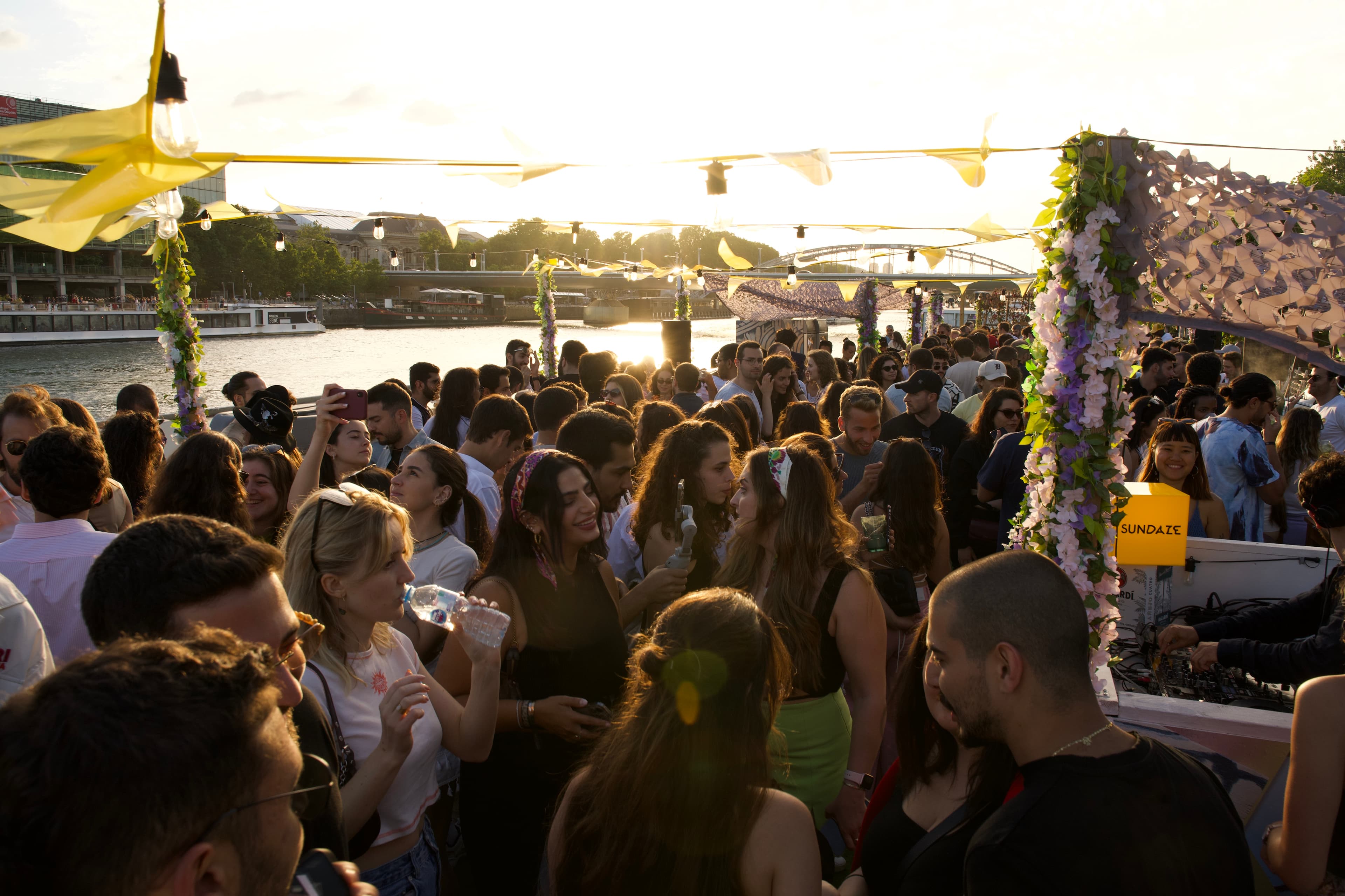 A SUNDAZE riverboat gathering on the Seine at sunset