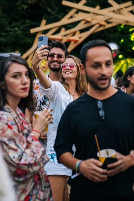 Hands reaching towards the camera in the crowd