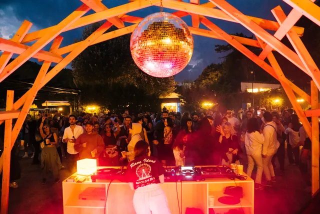 The garden turning to night beneath the mirror ball
