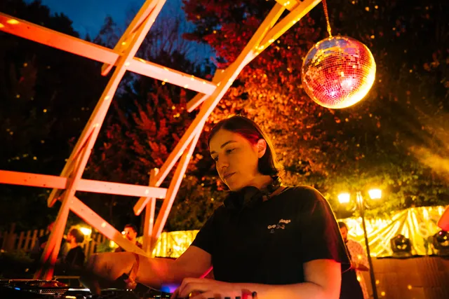 The DJ booth, wooden structure and mirror ball
