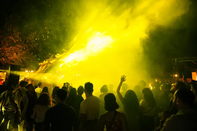 Yellow light passing above the crowd
