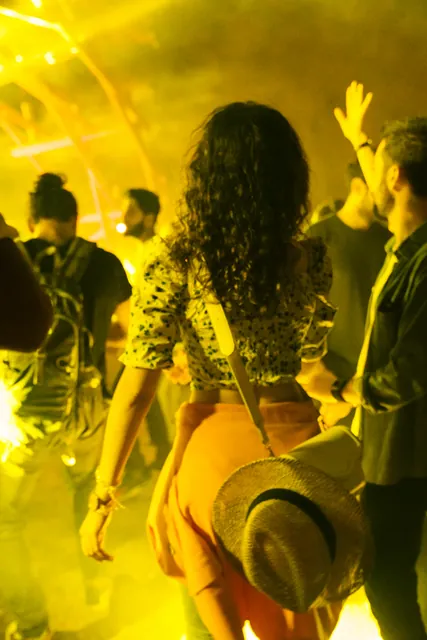 Dancers in a wash of yellow light