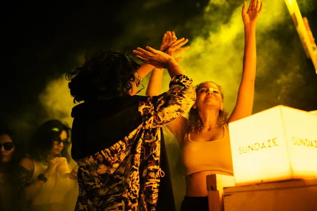 Guests dancing in front of the booth