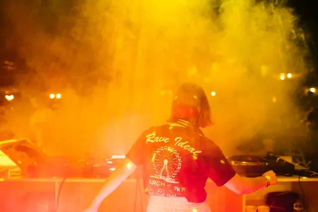 Behind the booth through smoke and light