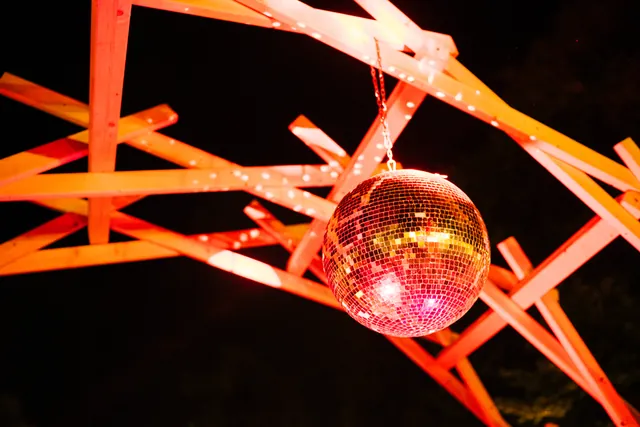 A mirror ball hanging in the wooden structure
