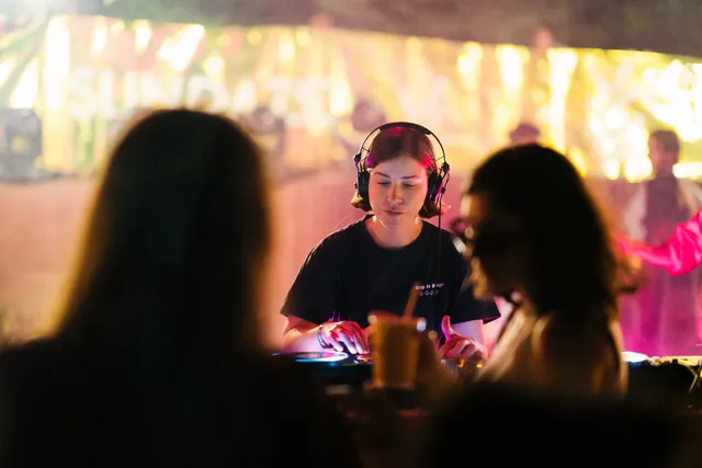 The DJ booth seen between listeners