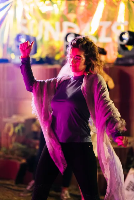 A guest in purple under the night lights