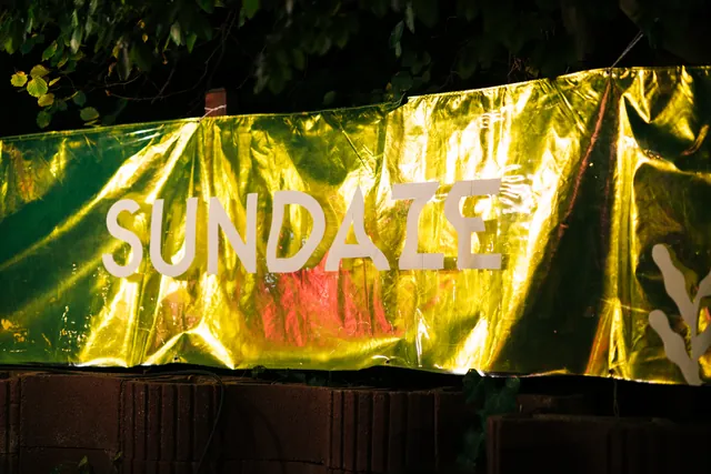 The SUNDAZE flag lit at night